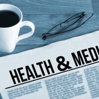 A cup of coffee, glasses and newspaper titled Health Medical